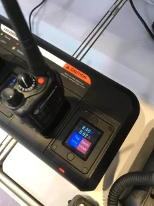 Two walkie talkies charging on a battery charger